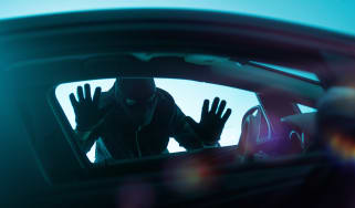 Car thief looking through a window