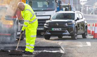 Pothole repair taking place with Citroen in the background